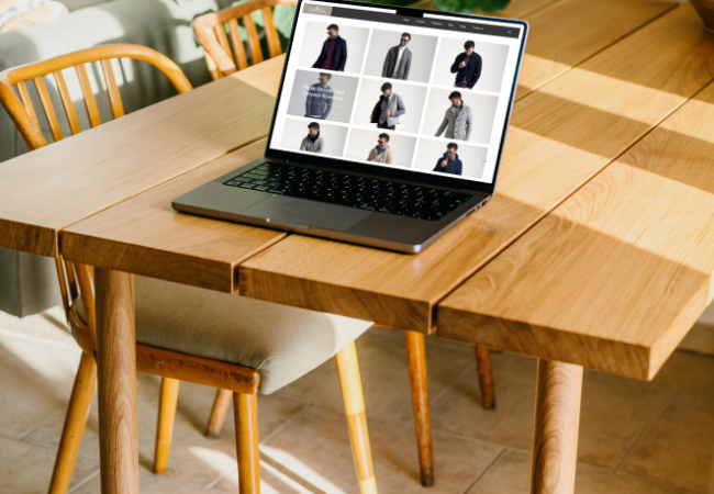 MacBook Pro mockup on a table with a plant in the background (Mockuuups Studio)